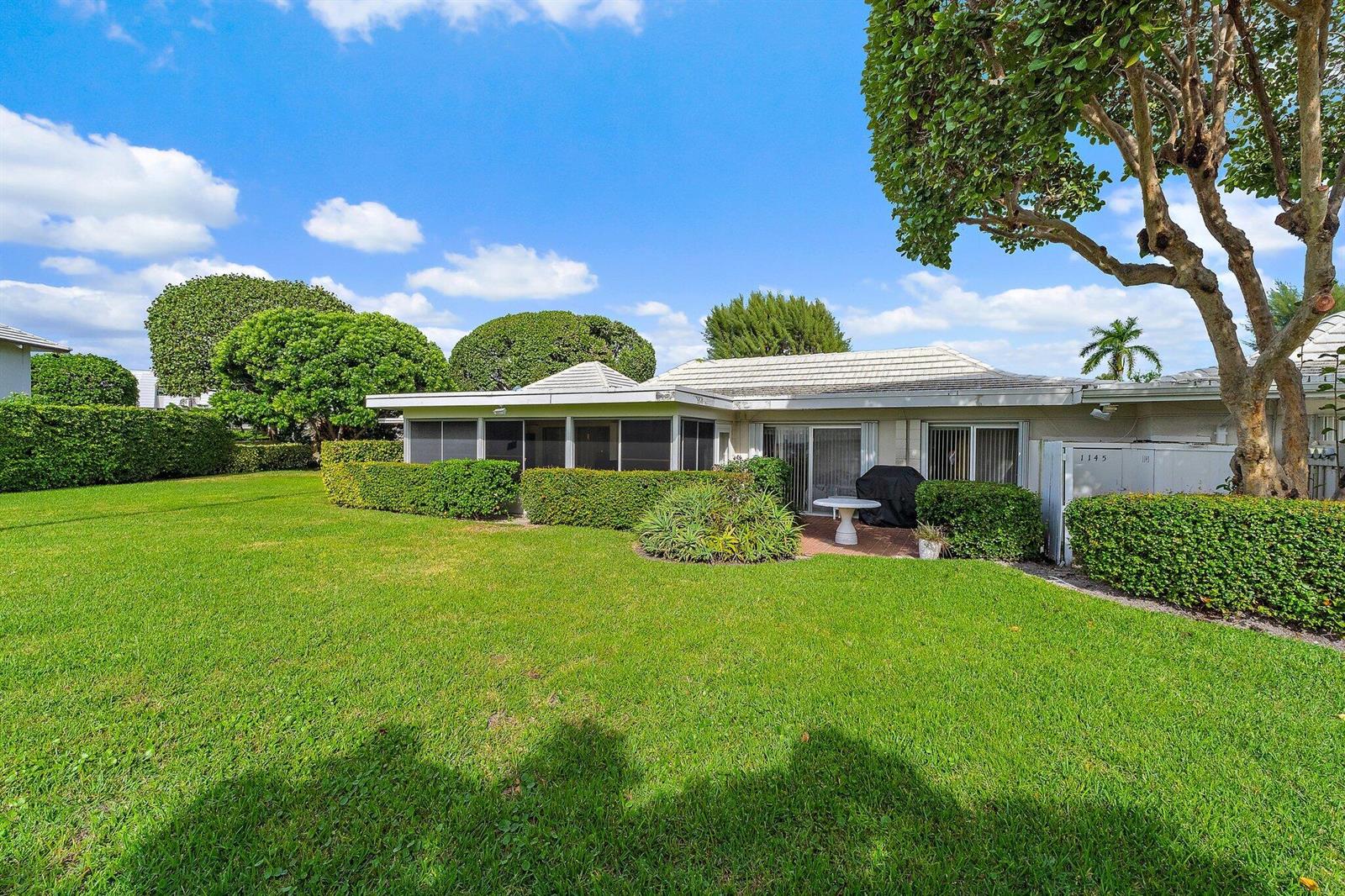 A single-story house with a screened-in porch, a patio, and a large grassy backyard — 1145 Sugar Sands Boulevard, Singer Island FL 33404, SINGER ISLAND, FL