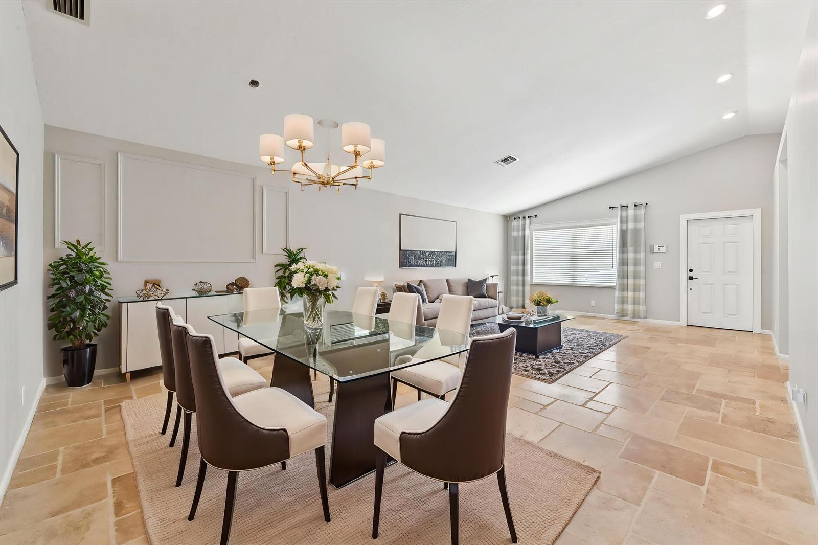 A dining area with a glass table and chairs sits adjacent to a living room — 1163 Peninsula Way, FL 33413, FL