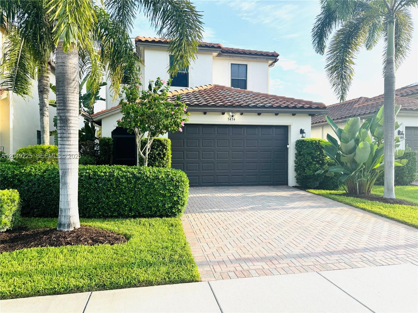 A living room features red and blue armchairs, a glass coffee table, and tile flooring — 5434 USEPPA DR, Ave Maria FL 34142, AVE MARIA, FL