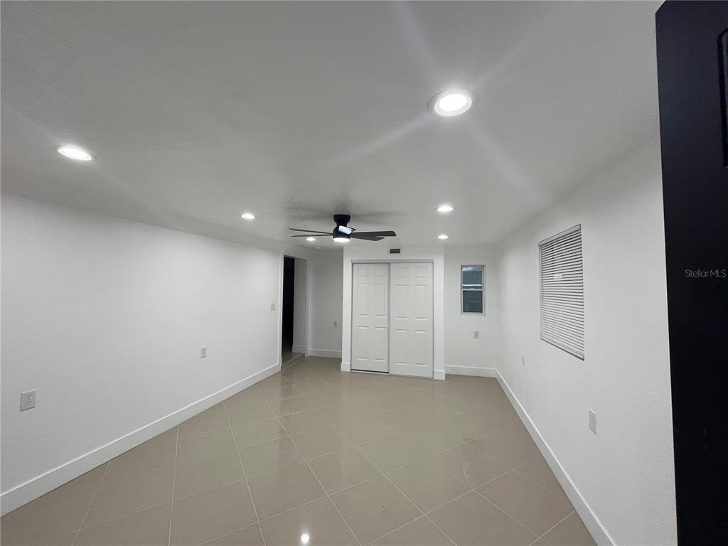 A room with white walls, recessed lighting, a ceiling fan, and light-colored tile flooring — 7119-7121 OAKWOOD, NEW PORT RICHEY, FL