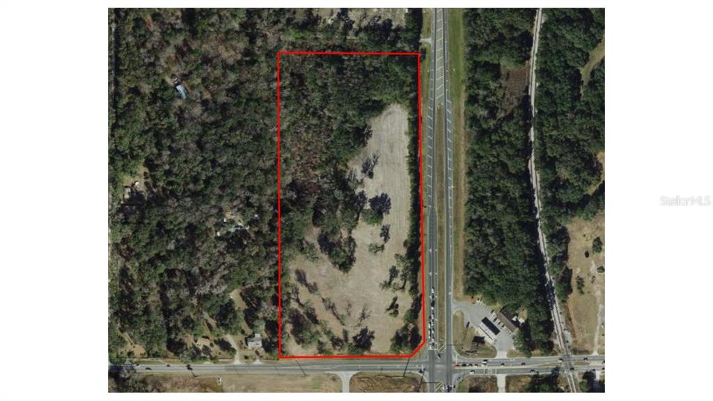 An aerial view shows a rectangular plot of land outlined in red next to a highway — 00 S US Highway 301, SUMMERFIELD, FL