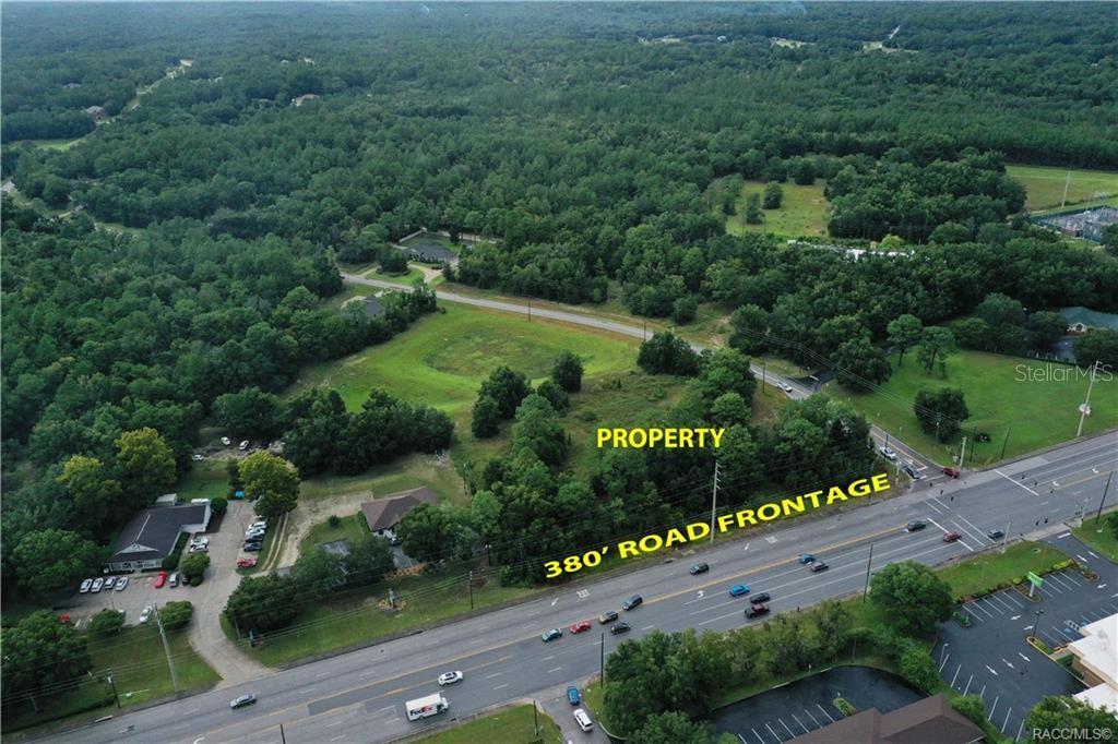 An aerial view shows a vacant, wooded lot with road frontage along a busy highway — 2314 W PERCHWOOD DRIVE, BEVERLY HILLS, FL