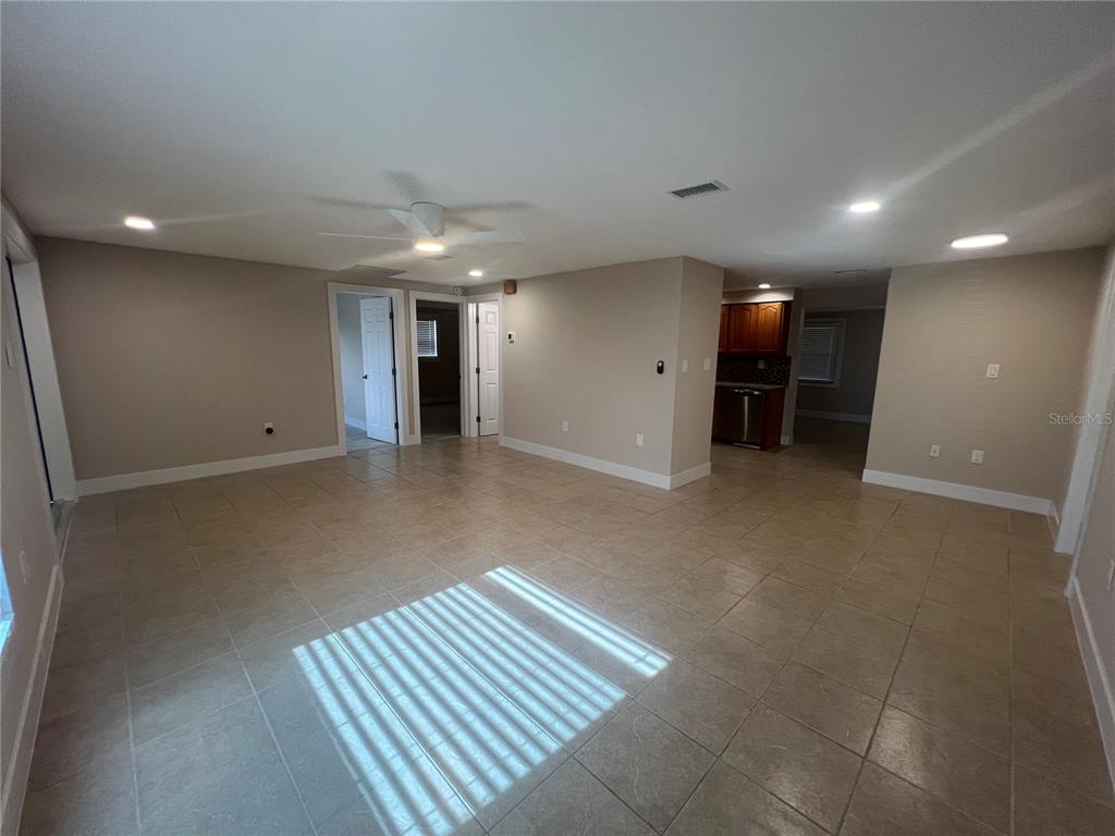 A spacious room with beige tile flooring, recessed lighting, and a ceiling fan — 249 SEMINOLE BOULEVARD NW, PORT CHARLOTTE, FL