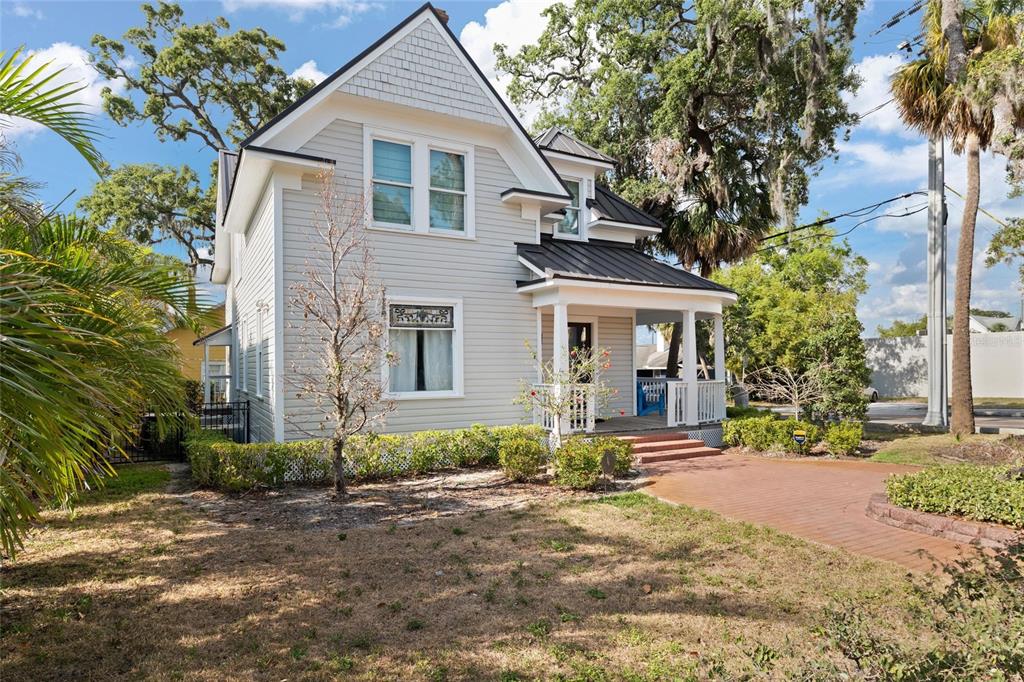 A two-story light gray house with a front porch and a metal roof — 4 W ORANGE STREET, TARPON SPRINGS, FL