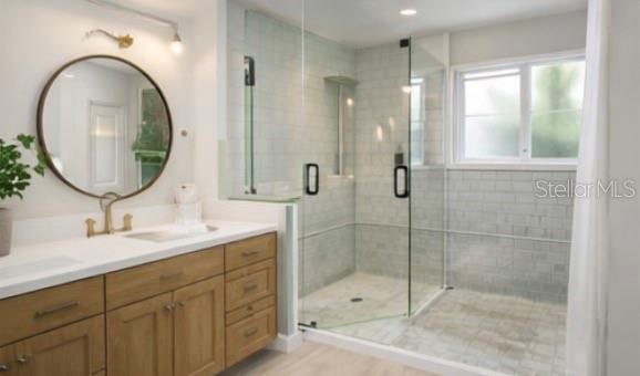 An empty room with white walls, wood-look flooring, and large windows overlooking a neighborhood street — 2317 GROVE STREET, SARASOTA, FL