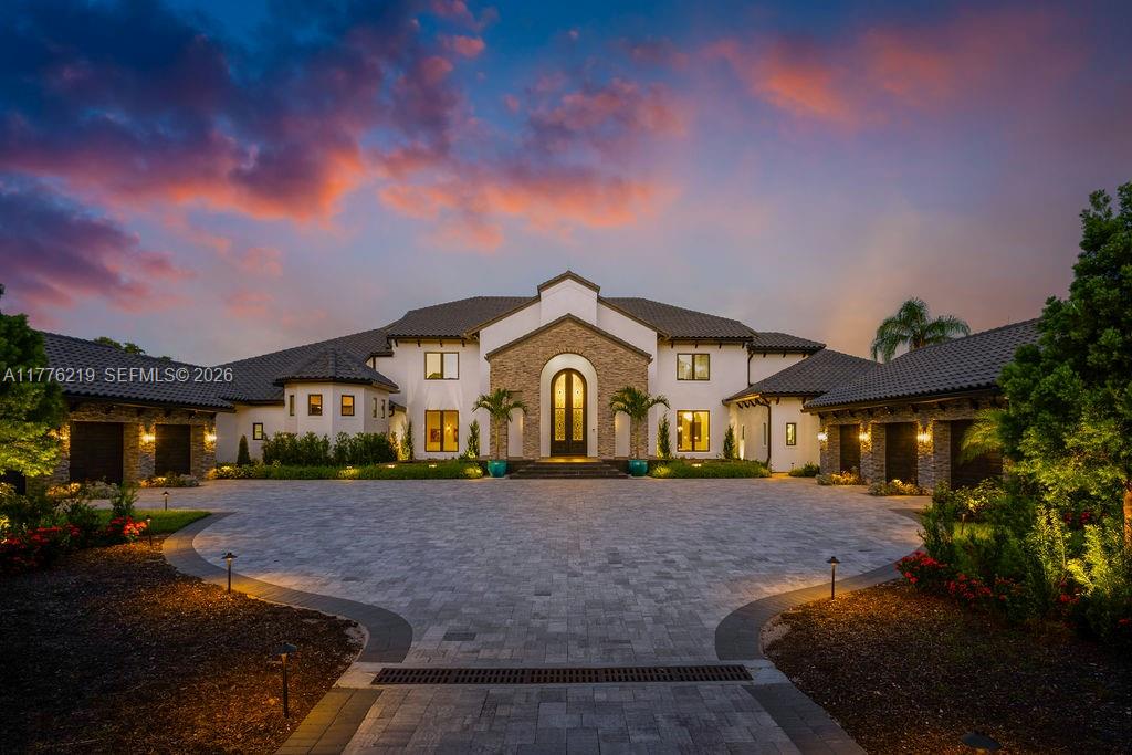 A large, two-story Mediterranean-style house with a stone facade and a paved circular driveway — 570 Manor Rd, Maitland, Winter Park FL 32751, WINTER PARK, FL