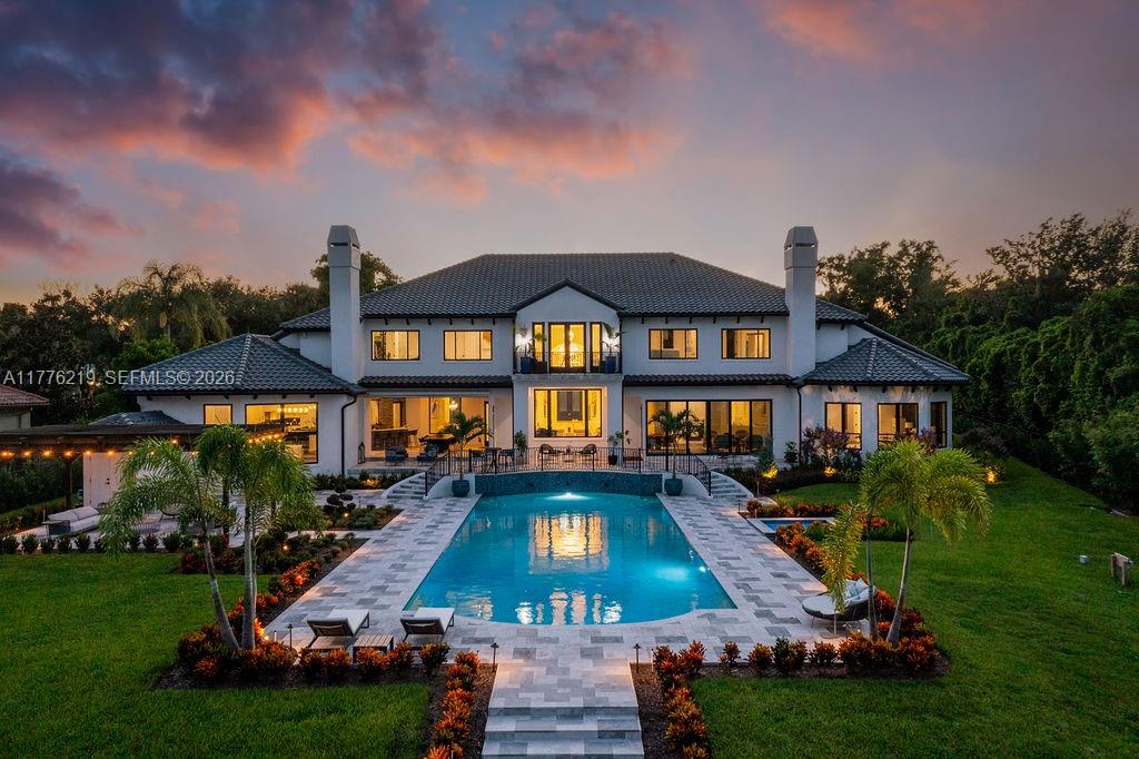 A large two-story house with a swimming pool and patio at sunset — 570 Manor Rd, Maitland, Winter Park FL 32751, WINTER PARK, FL