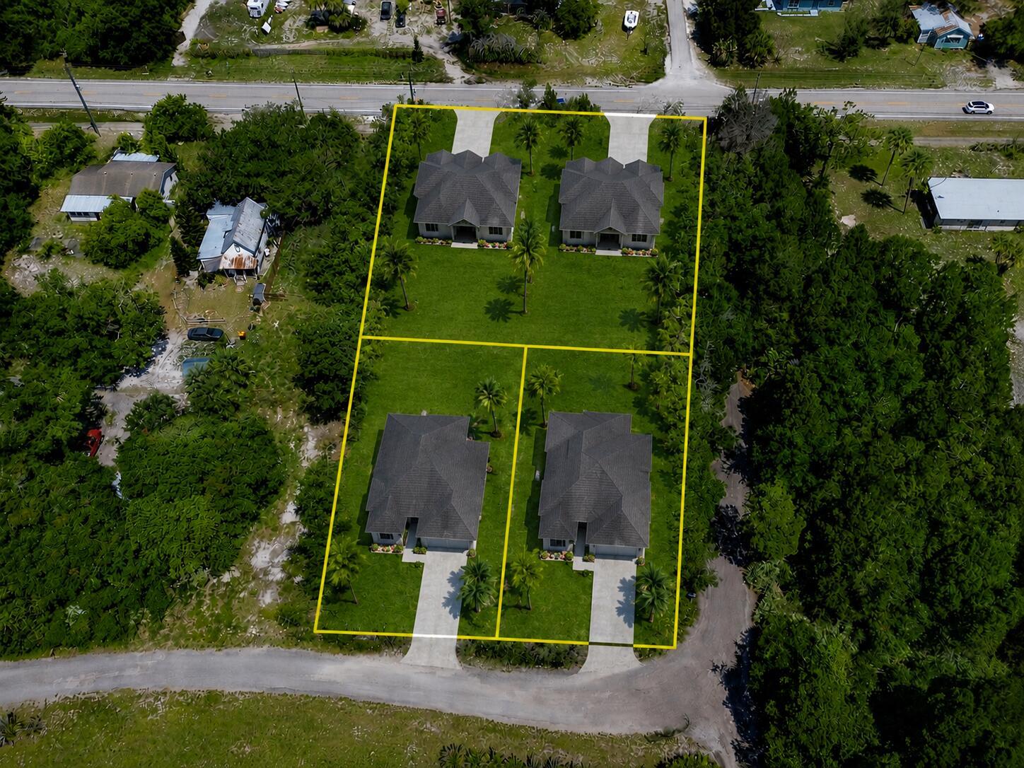 An aerial view shows four houses on a large lot with yellow boundary lines — 12850 Roseland Road, Sebastian FL 32958, SEBASTIAN, FL