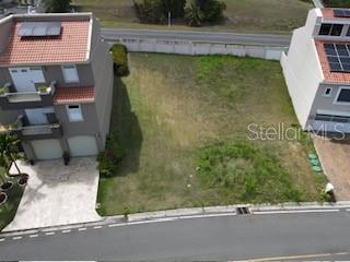 An aerial view shows a vacant rectangular lot situated between two multi-story residential buildings — MARINA VIEW 5 UNIT 5, HUMACAO, PR