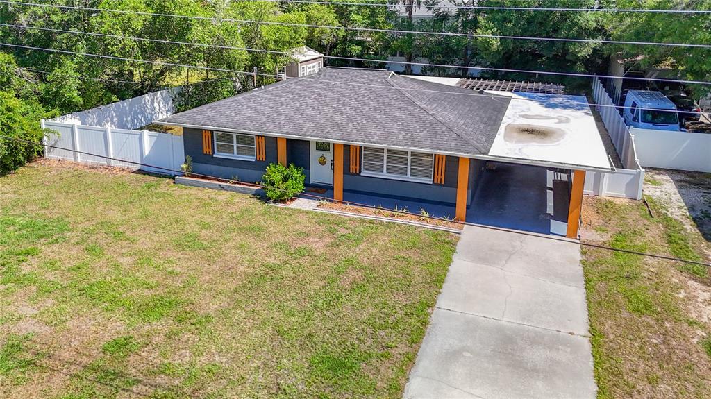 An aerial view of a single-story house with a gray exterior, orange accents, and carport — 135 CONNIE AVENUE, TAMPA, FL