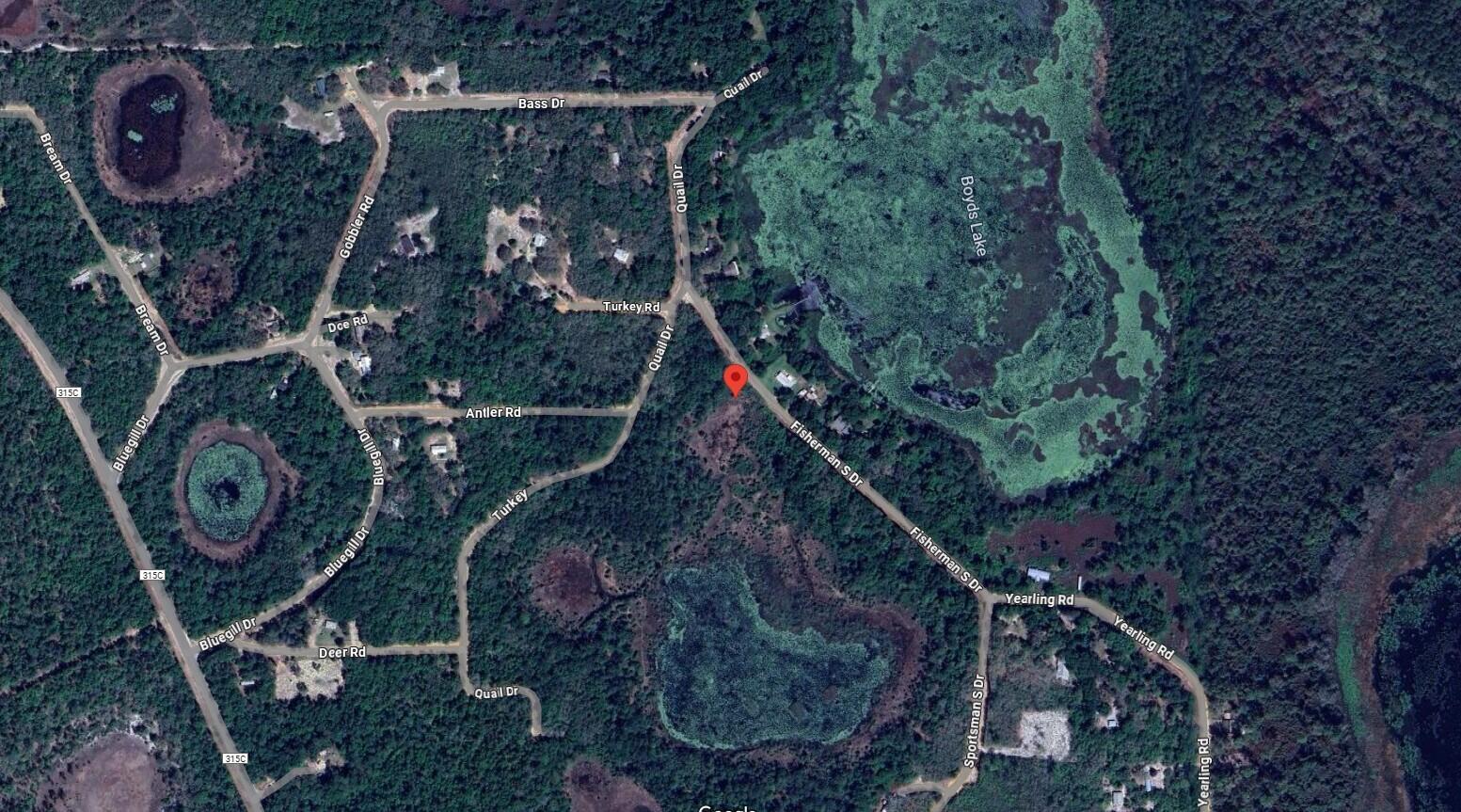 This is a satellite map view of a wooded residential area with several named roads — 129 Fishermans Drive, FL 32148, FL