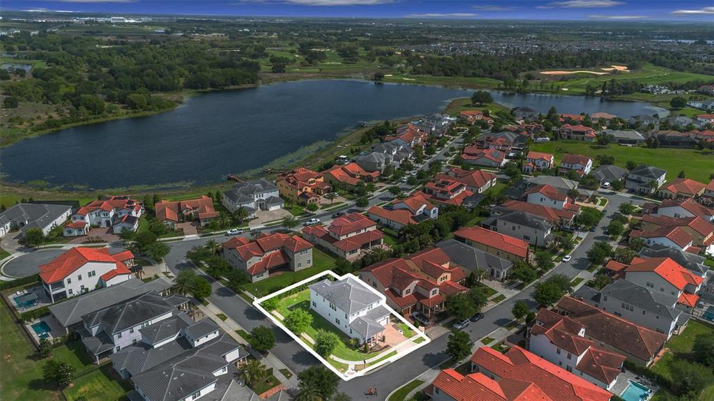 An aerial view shows a two-story house with a gray roof and backyard patio — 15161 CANOE PLACE, WINTER GARDEN, FL