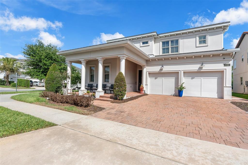 An aerial view shows a single-family home with a dark roof on a corner lot — 15161 CANOE PLACE, WINTER GARDEN, FL