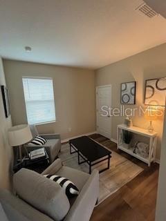 A living room features two armchairs, a coffee table, and a console table against a wall — 10274 SW 99TH LANE, OCALA, FL