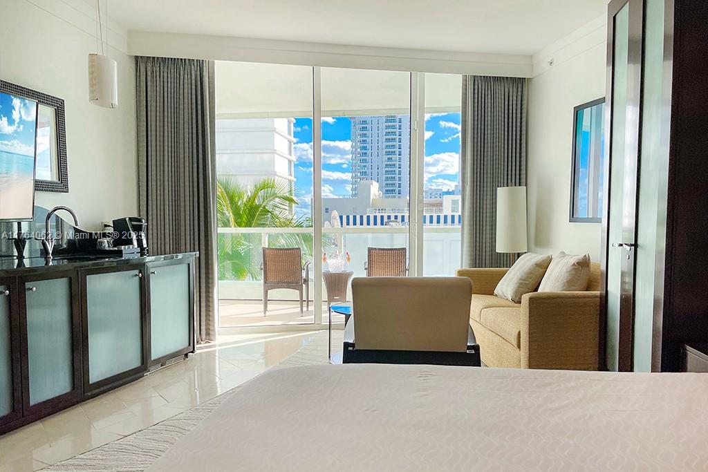 A hotel room features a kitchenette, a sofa, and a balcony with outdoor seating — 4391 Collins ave # 616, Miami Beach FL 33140, MIAMI BEACH, FL