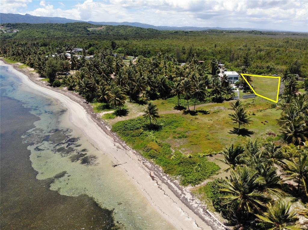 An aerial view shows a coastal property with a highlighted vacant lot near the beach — 968 CAMINO LAS PICUAS 1, RIO GRANDE, PR
