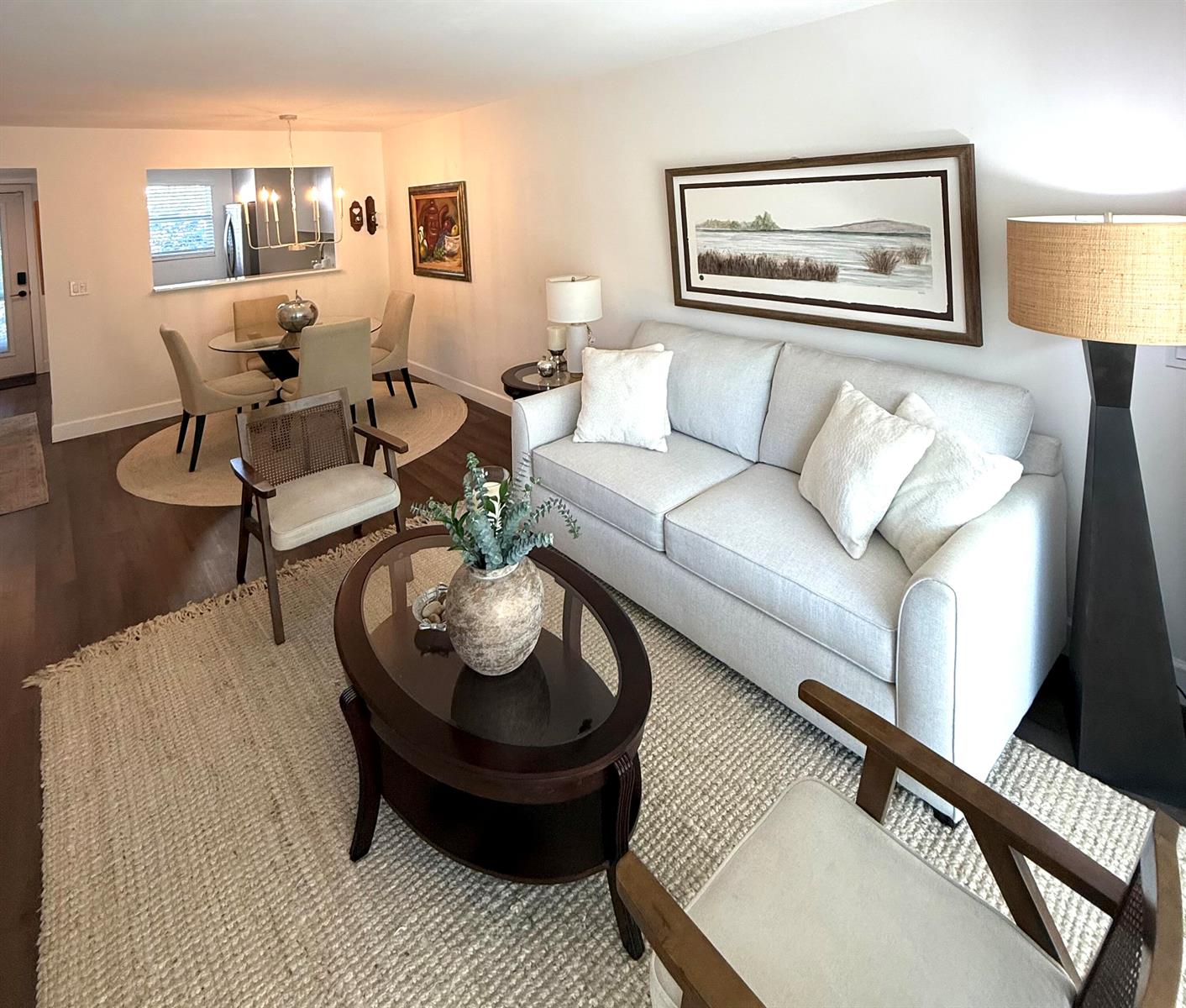 A living room with a light gray sofa, oval coffee table, and adjacent dining area — 3170 Holiday Springs Boulevard # 304, Margate FL 33063, MARGATE, FL
