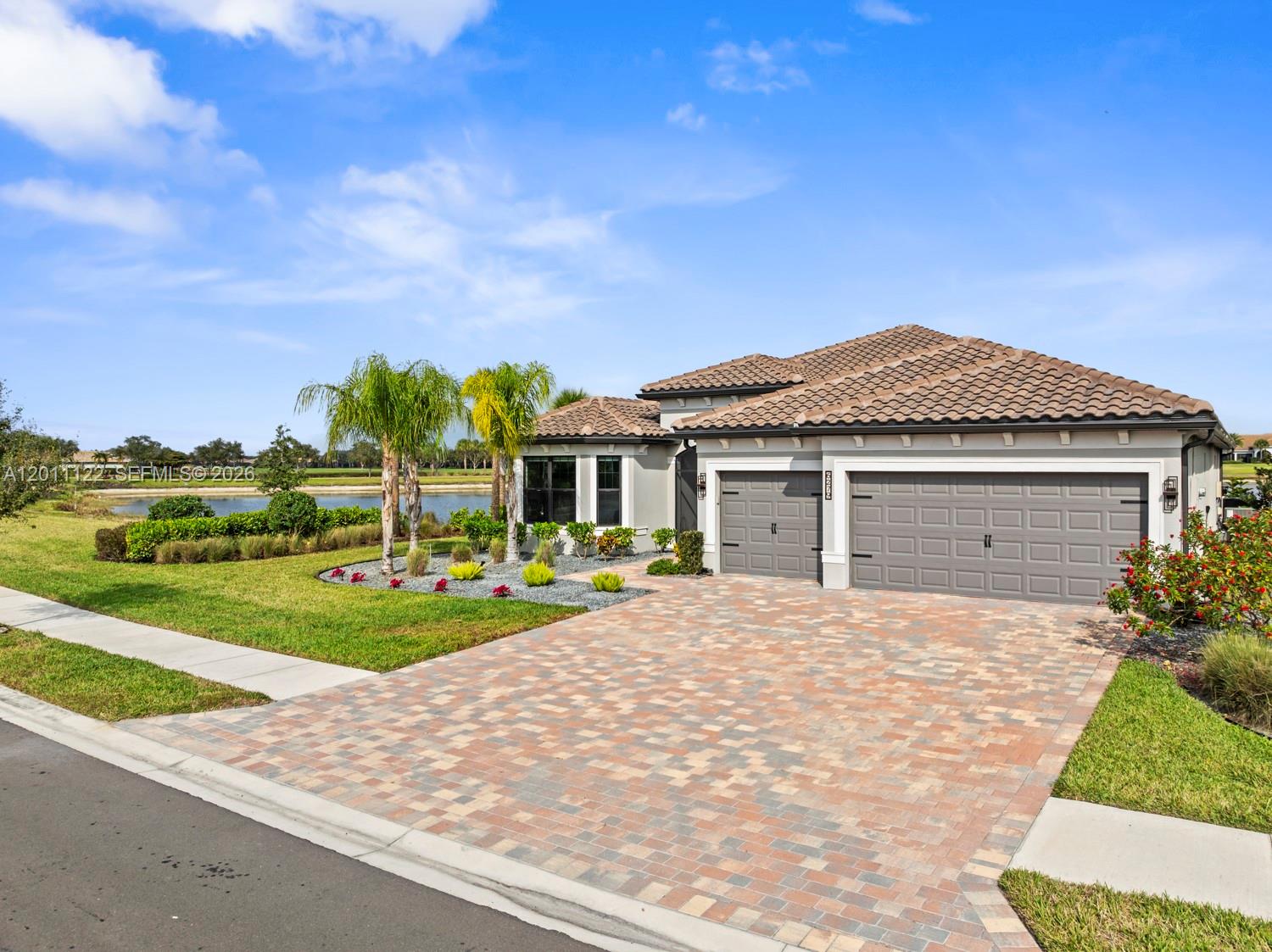 A single-story house with a tiled roof, gray garage doors, and a paved driveway — 6279 LIBERTY ST, Ave Maria FL 34142, AVE MARIA, FL