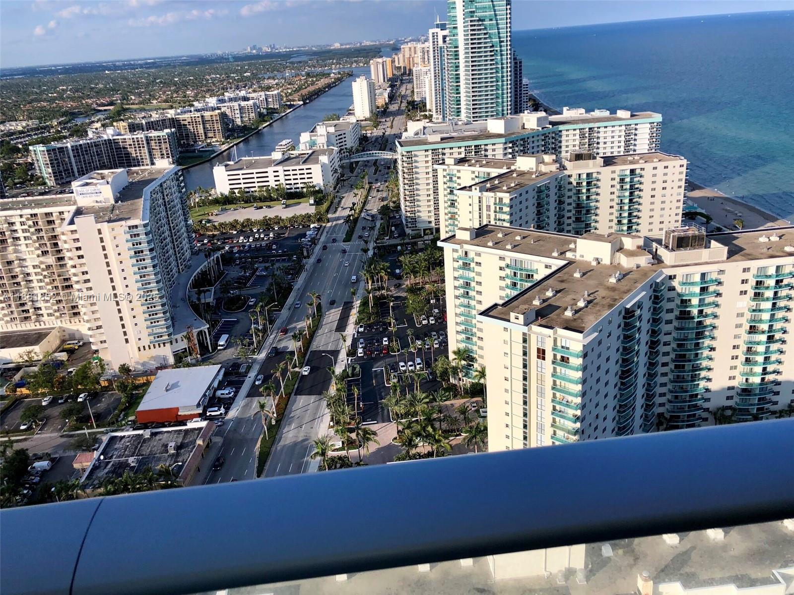 An elevated view shows a coastal city street lined with high-rise buildings and parking lots — 4111 S Ocean Dr # 2910, Hollywood FL 33019, HOLLYWOOD, FL