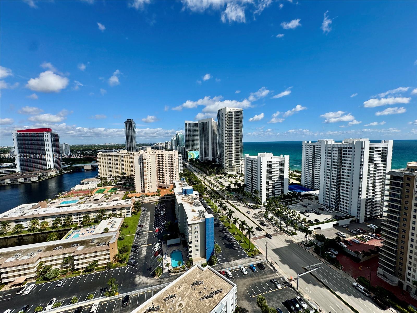 An elevated view of a coastal city skyline featuring high-rise buildings, a road, and parking — 1945 S Ocean Dr # 2311, Hallandale Beach FL 33009, HALLANDALE BEACH, FL