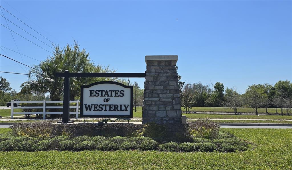 A stone monument sign for Estates of Westerly stands in a grassy residential area — 5629 WESTERN SUN DRIVE, ST CLOUD, FL