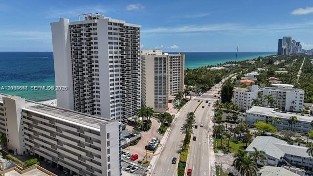 An aerial view shows high-rise apartment buildings situated along a coastal road near the ocean — 3140 S Ocean Dr # 1705, Hallandale Beach FL 33009, HALLANDALE BEACH, FL