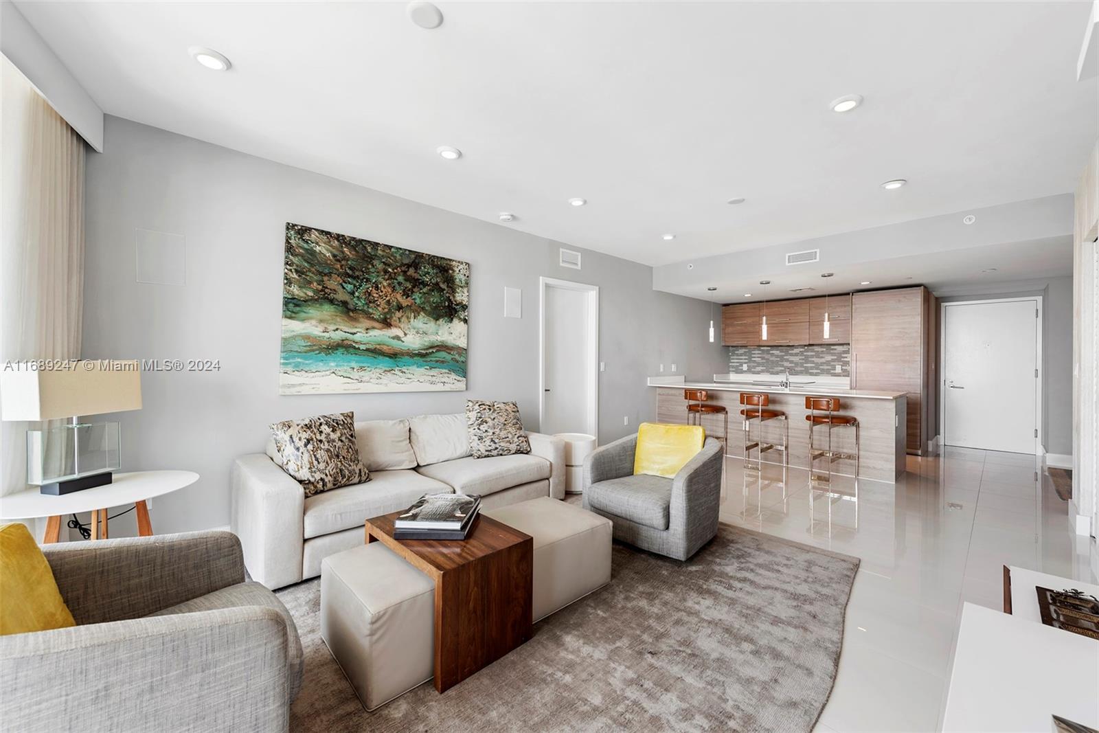 A living room features a sofa, two armchairs, a coffee table, and an open kitchen — 1300 S Miami Ave # 3402, Miami FL 33130, MIAMI, FL