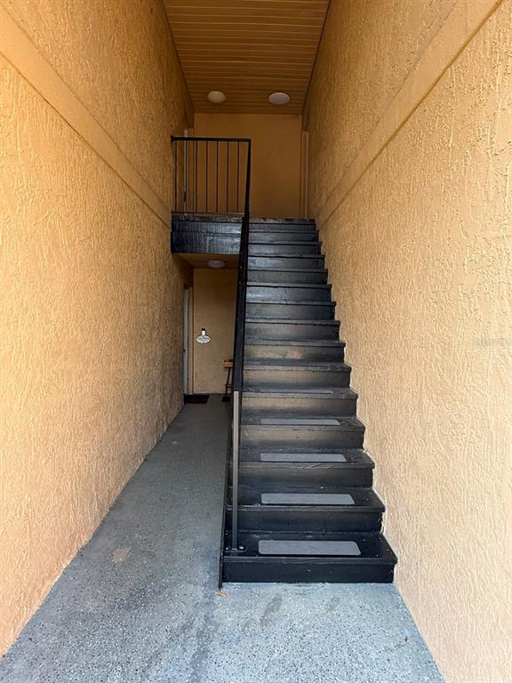 An outdoor staircase with black steps and a metal railing leads to an upper landing — 2400 BARLEY CLUB COURT UNIT 3, ORLANDO, FL