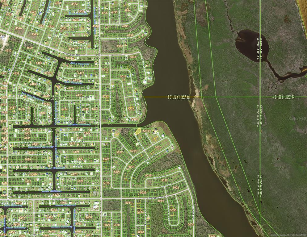 This is an aerial map showing residential streets, canal waterways, and adjacent undeveloped land — 10116 LA GRANGE COURT, PORT CHARLOTTE, FL