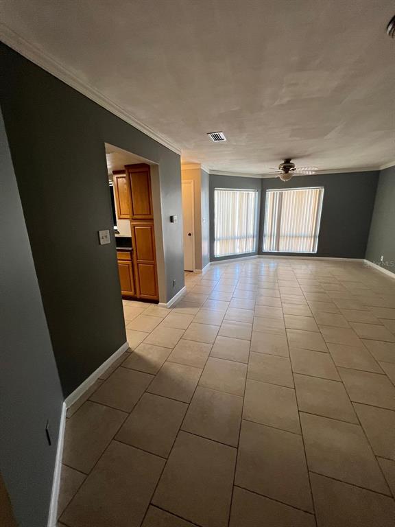 A two-story apartment building exterior with a metal staircase, white stucco walls, and pine trees — 2634 LEMON TREE LANE UNIT H, ORLANDO, FL