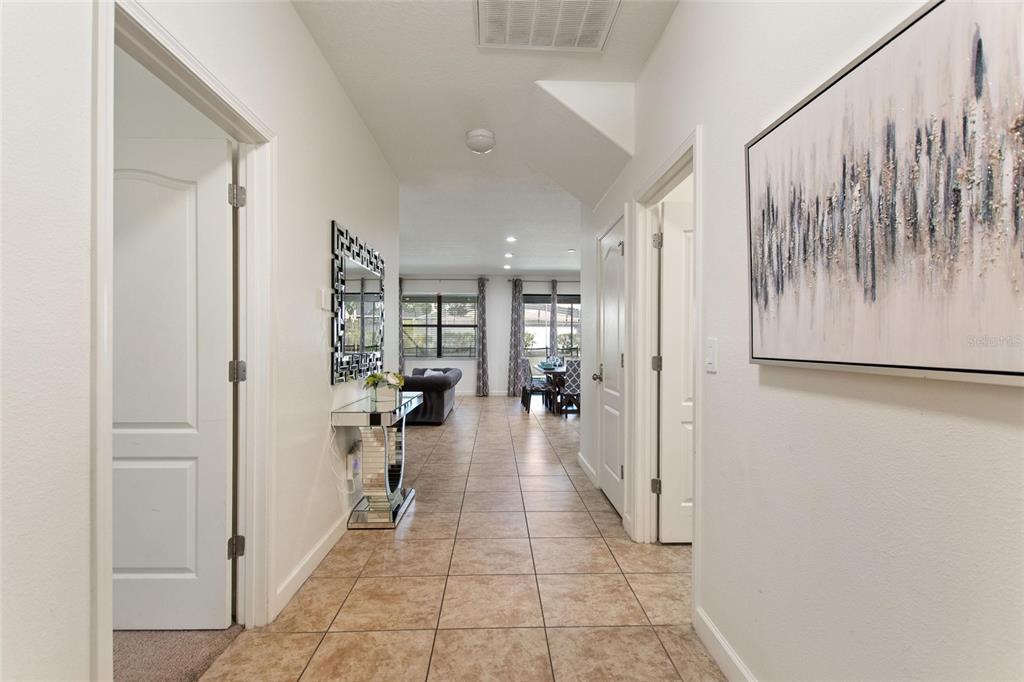 A tiled hallway leads from the entryway toward a living and dining area — 1428 THUNDERBIRD ROAD, DAVENPORT, FL