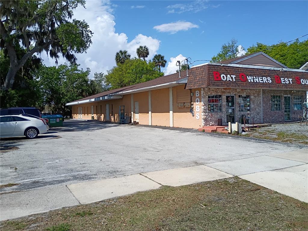 A single-story commercial building with a tan exterior and a stone-faced front entrance — 5110 S RIDGEWOOD AVENUE, PORT ORANGE, FL