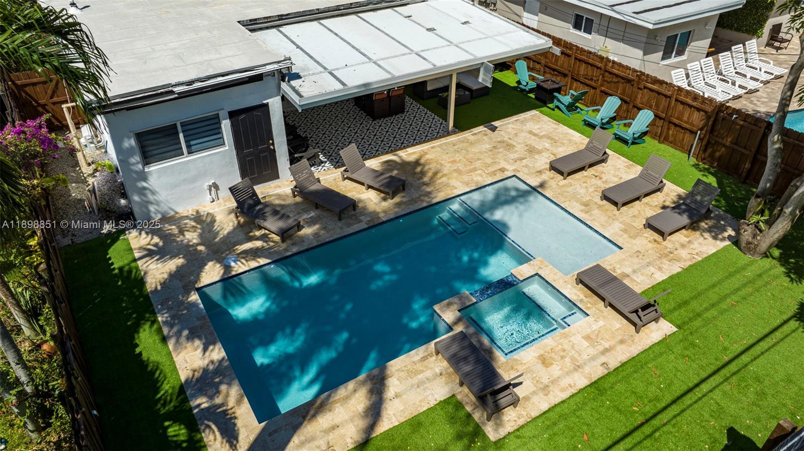 An aerial view shows a swimming pool and spa surrounded by a stone patio — 1230 Johnson St, Hollywood FL 33019, HOLLYWOOD, FL