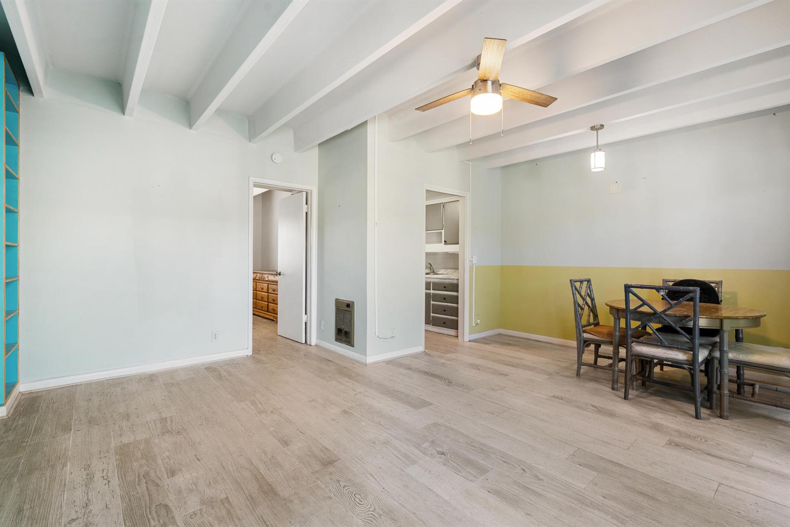 A dining area features light wood floors, exposed ceiling beams, and a two-toned wall — 702 N Federal Highway # B4, FL 33460, FL