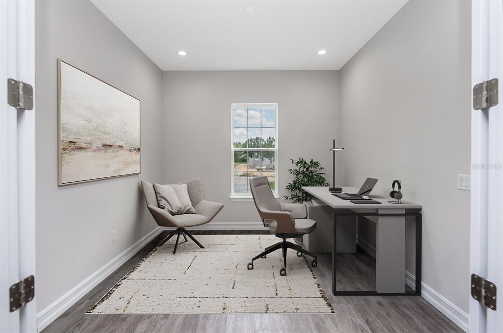 A home office features gray walls, wood-look flooring, a desk, and a swivel chair — 13189 SW 61ST PLACE ROAD, OCALA, FL