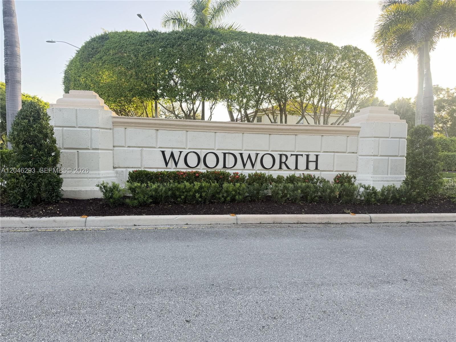 A stone monument sign with the name Woodworth stands in front of trees and palms — 9640 Wyeth Ct, Wellington FL 33414, WELLINGTON, FL
