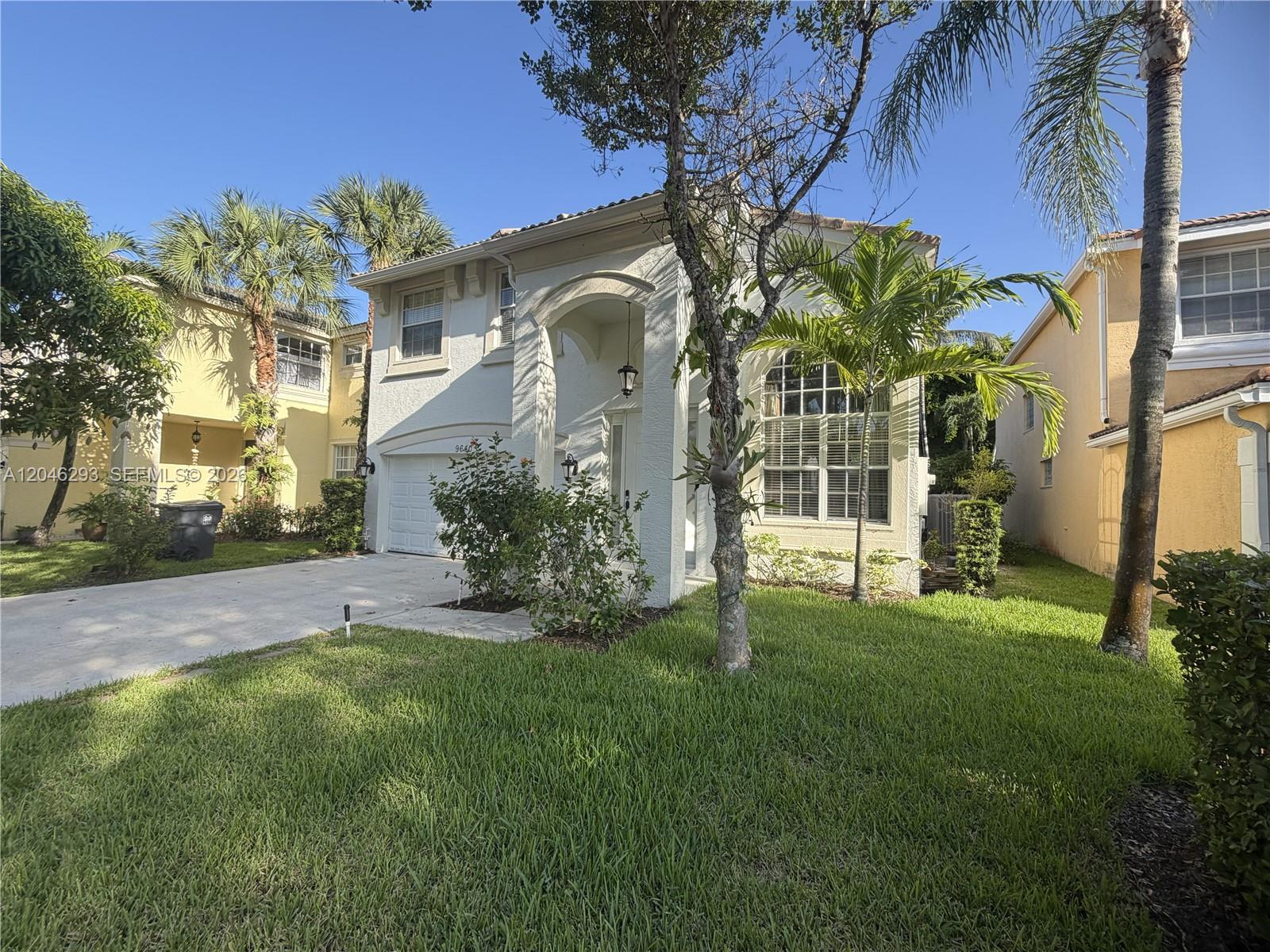 A two-story white stucco house with a garage and palm trees in the front yard — 9640 Wyeth Ct, Wellington FL 33414, WELLINGTON, FL