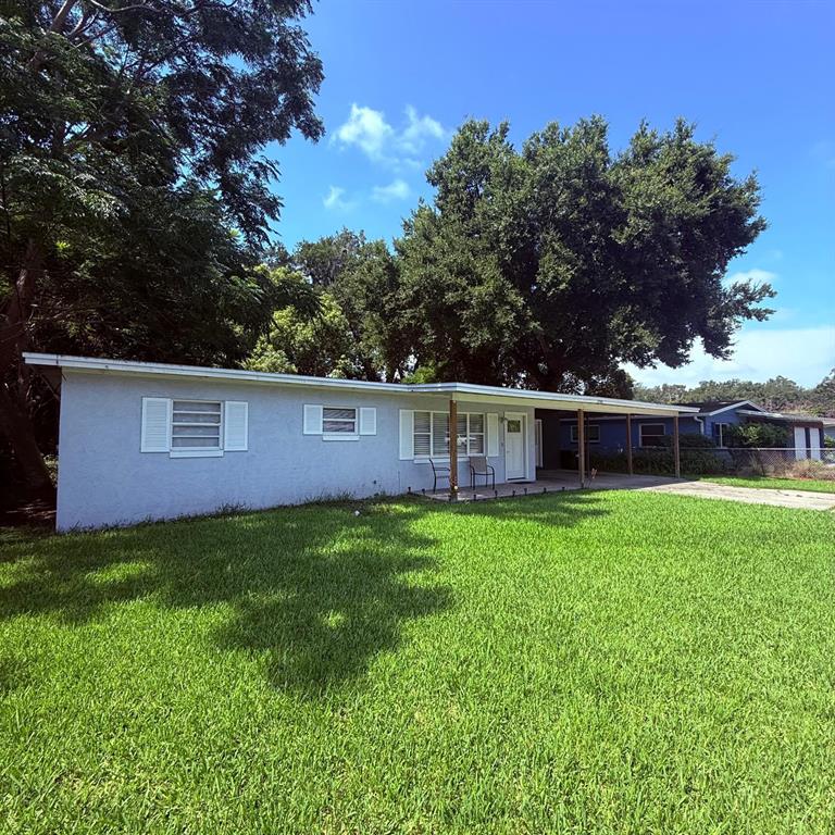 A light blue single-story house features a front porch and a large grassy lawn — 2940 LAKE MARGARET DRIVE, ORLANDO, FL