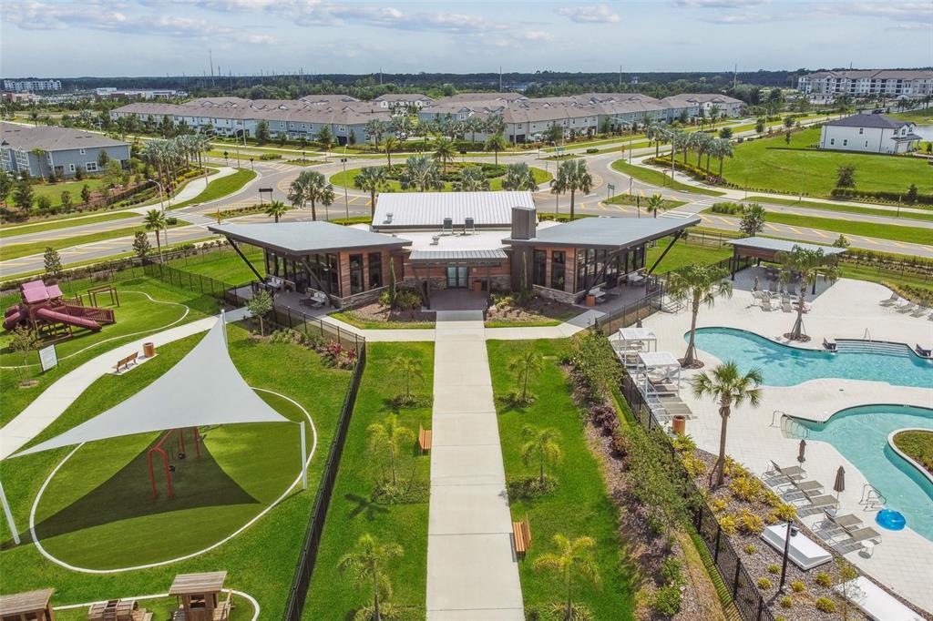 An aerial view of a community clubhouse with a swimming pool and a playground — 5678 JEFFRIES WAY, WESLEY CHAPEL, FL