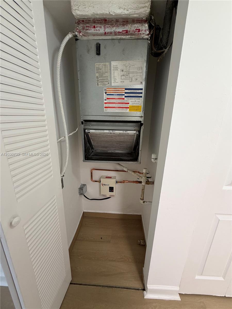 An indoor HVAC air handler unit is installed inside a small utility closet — 8560 N Sherman Cir # 404, Miramar FL 33025, MIRAMAR, FL