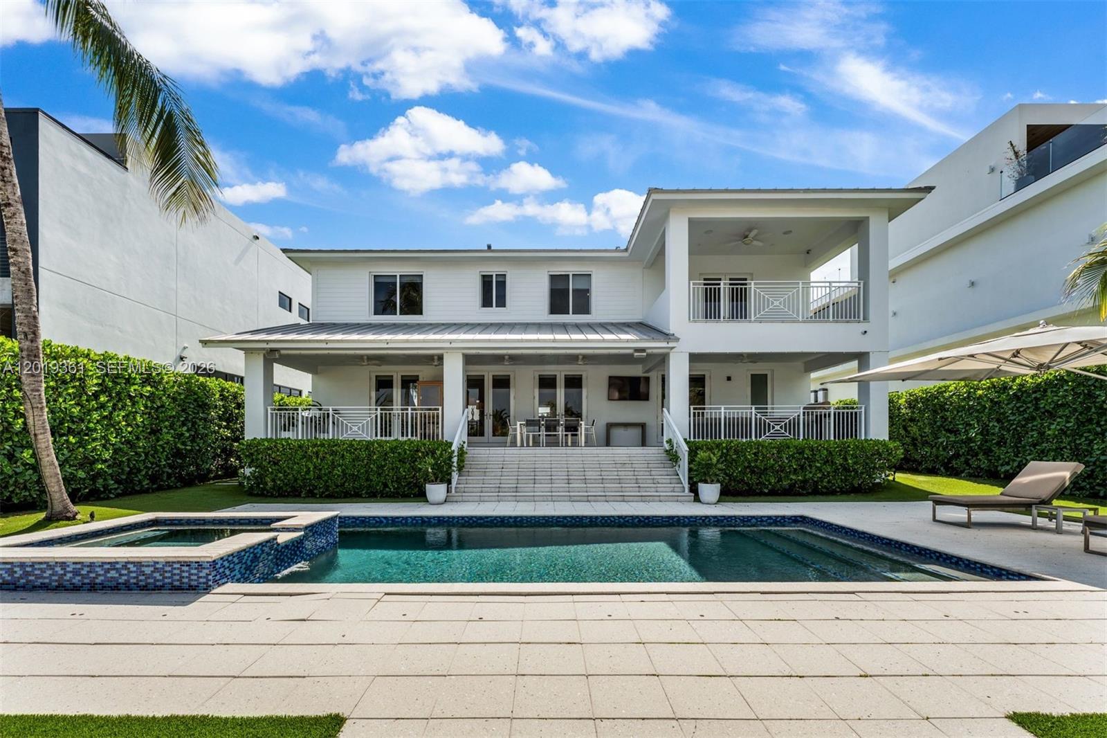 A two-story white house features a backyard swimming pool, patio, and landscaped hedges — 13040 N Bayshore Dr, North Miami FL 33181, NORTH MIAMI, FL