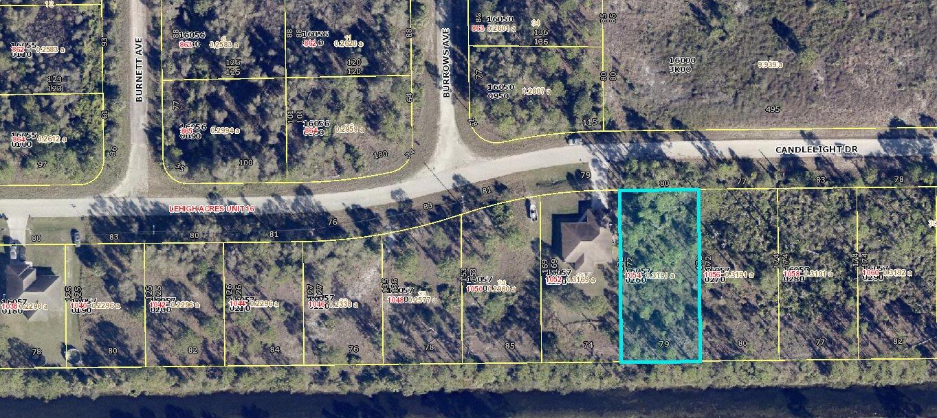 This is an aerial map showing a residential lot highlighted in blue along a canal — 1054 Candlelight Drive, Lehigh Acres FL 33974, LEHIGH ACRES, FL