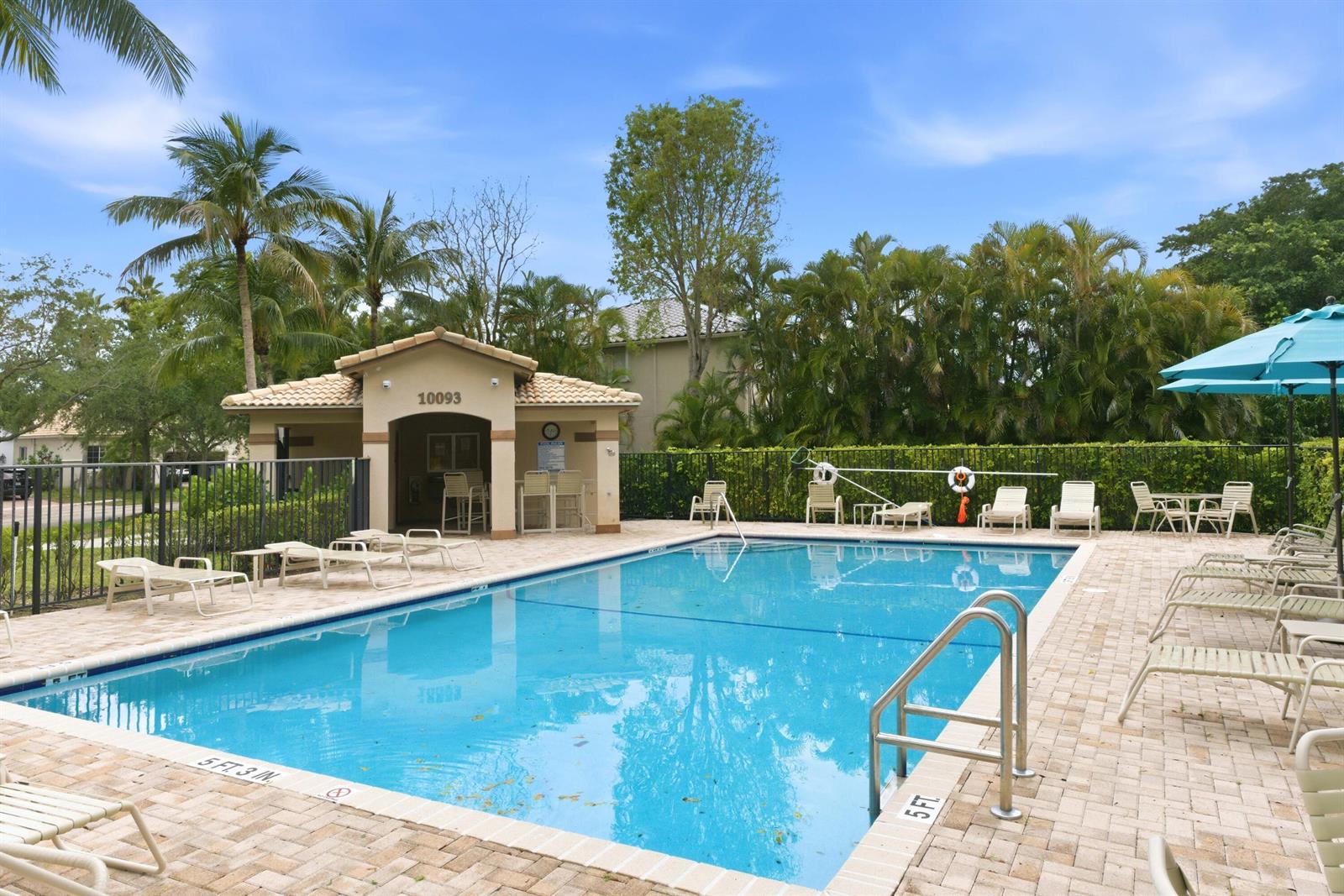 A rectangular outdoor swimming pool with lounge chairs and a small cabana building — 10134 Boca Vista Drive, Boca Raton FL 33498, BOCA RATON, FL