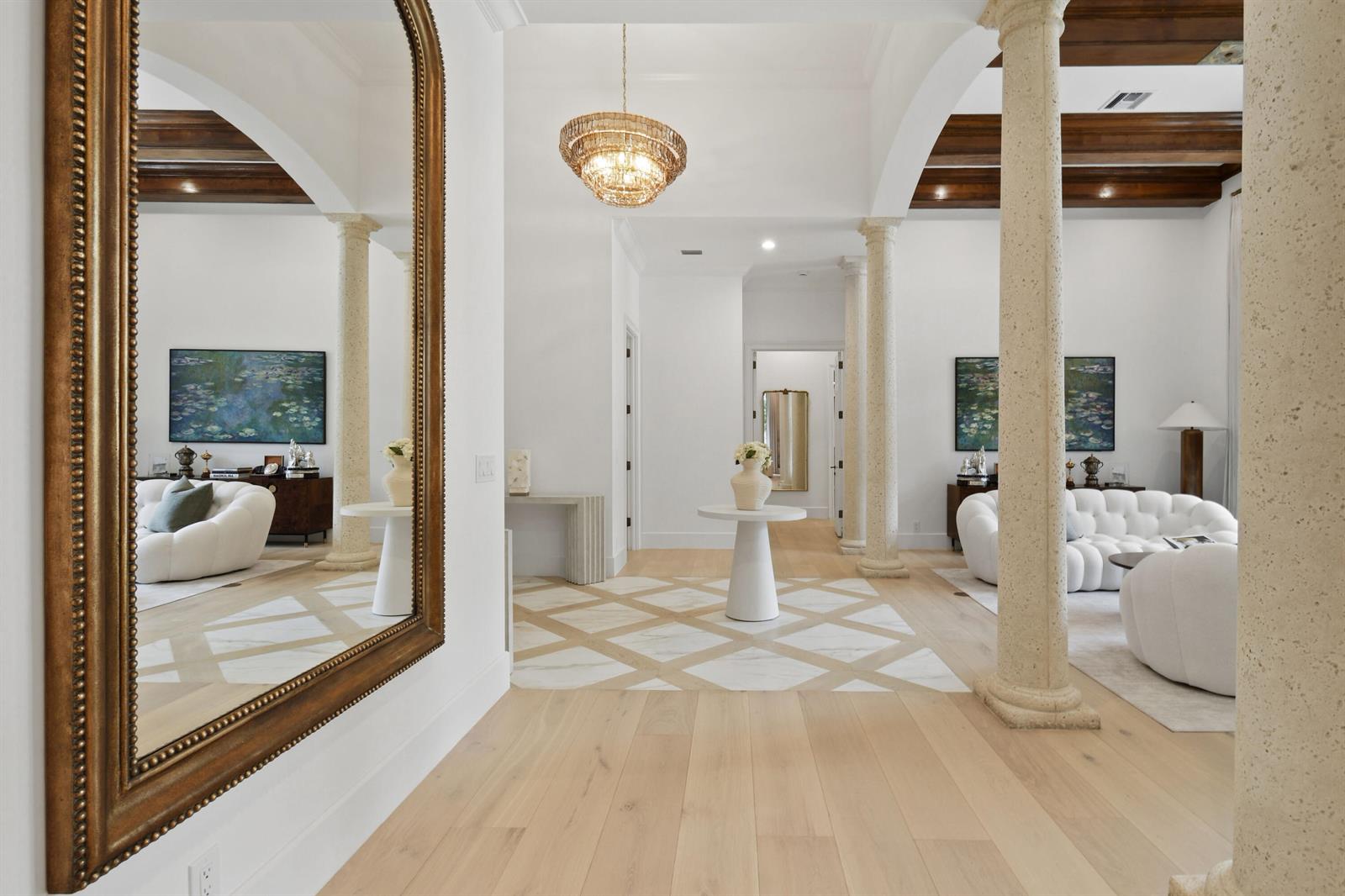 A bright foyer features stone columns, wood ceiling beams, and a white marble diamond-pattern floor — 147 Segovia Way, Jupiter FL 33458, JUPITER, FL
