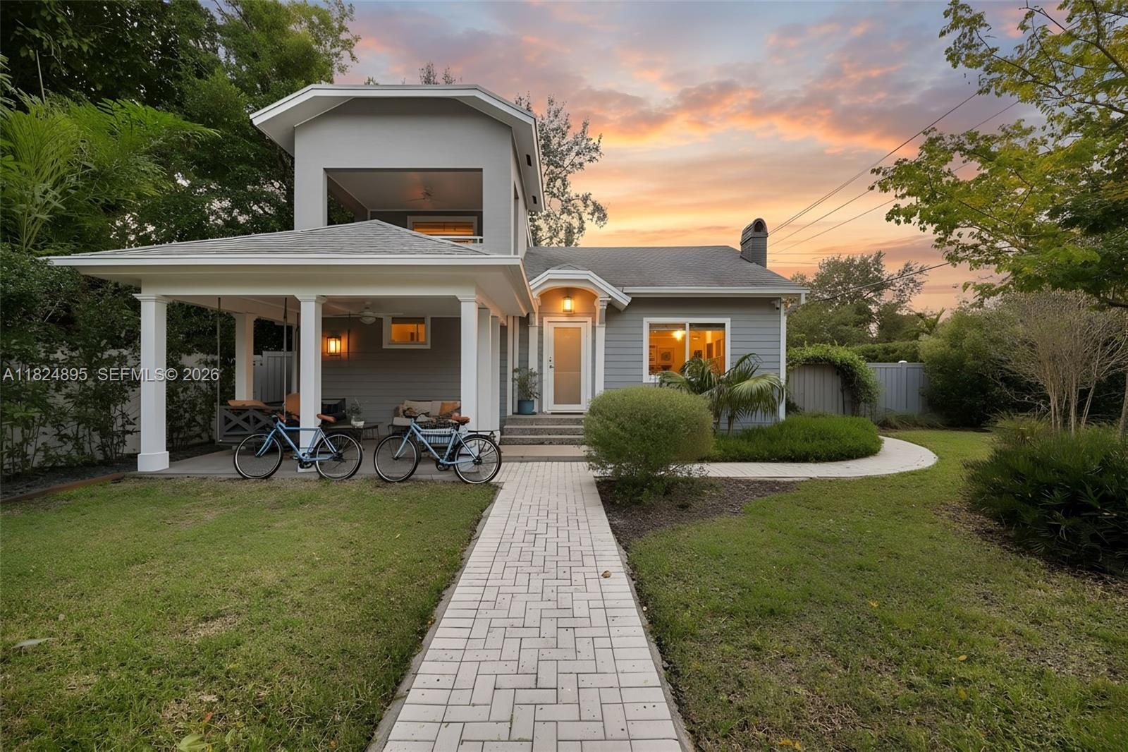 A two-story gray house with a covered front porch and a brick walkway — 150 NE 50 # A, Miami FL 33137, MIAMI, FL