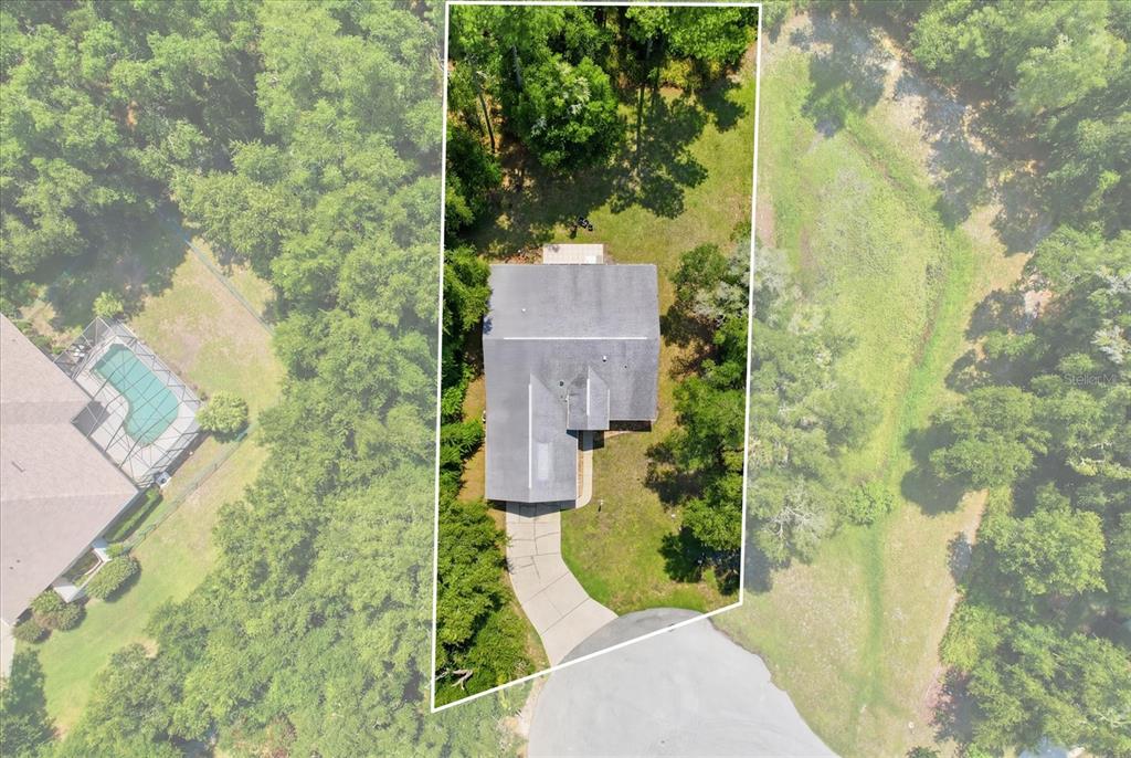 An aerial view shows a house with a driveway on a wooded lot — 18860 SW 99TH STREET, DUNNELLON, FL