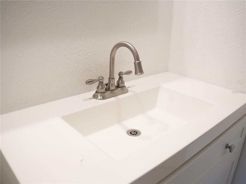 A white bathroom vanity features a rectangular sink and a brushed nickel faucet — 4406 S LAKE ORLANDO PARKWAY UNIT 2, ORLANDO, FL