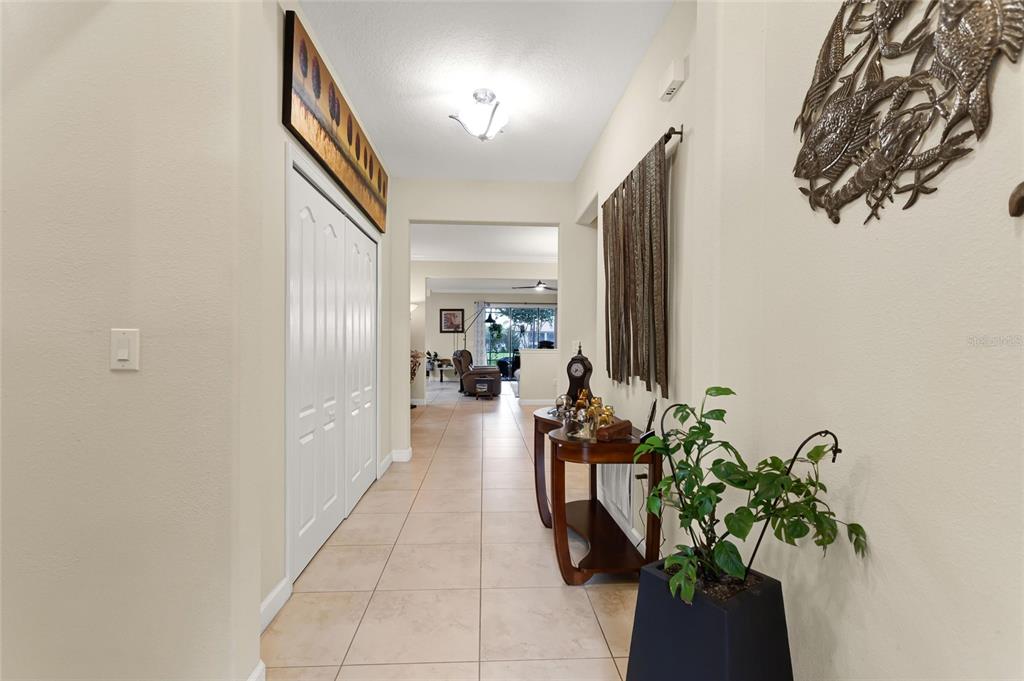 A tiled entryway leads into a living area with a closet and decorative wall art — 1353 PALMETTO DUNES ST, DAVENPORT, FL