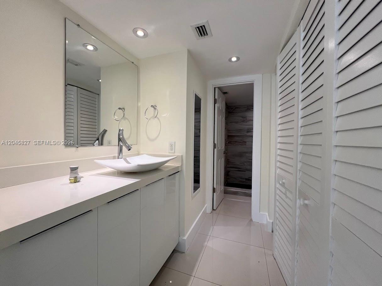 A modern bathroom features a vessel sink, white cabinetry, and a walk-in shower — 8205 SW 152nd Ave # 000, Miami FL 33193, MIAMI, FL