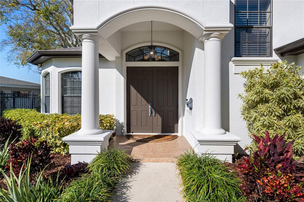 A white stucco house entrance features a double door, arched transom, and two large columns — 3598 10TH STREET NE, ST PETERSBURG, FL
